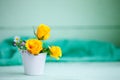 Yellow roses on a wooden table. An autumn background with copy space. Autumn still life.