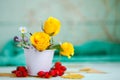 Yellow roses on a wooden table. An autumn background with copy space. Autumn still life.