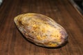 Yellow rotten mango fruit isolated on wooden