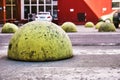 Yellow round car parking barriers on zebra crossing