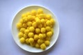 Yellow round corn snacks on a white plate Royalty Free Stock Photo
