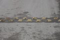 Yellow round metal restraints in a speed bump