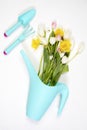 The Yellow rubber boots with a bouquet of flowers of yellow daffodils and white and pink tulips. Garden accessories. Royalty Free Stock Photo