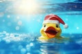Yellow rubber duck floating on blue water in a pool on a Christmas day