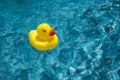 Yellow Rubber Duck Floating in Blue Water in a Swimming Pool