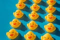 Yellow rubber ducks on a blue background with hard shadows Royalty Free Stock Photo