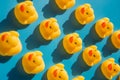 Yellow rubber ducks on a blue background with hard shadows Royalty Free Stock Photo