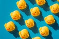 Yellow rubber ducks on a blue background with hard shadows Royalty Free Stock Photo