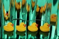 Yellow rubber ducks on green metallic shimmers background