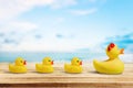 Yellow rubber ducks on wooden table Royalty Free Stock Photo
