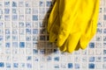 Yellow rubber gloves for cleaning the bath with blue tile on the background - Image