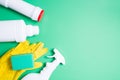 yellow rubber gloves, green sponges for washing and several different types of white plastic bottles without labels for detergents Royalty Free Stock Photo