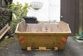 Yellow rubbish skip outdoors Royalty Free Stock Photo