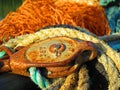 Yellow, rusty and blue mooring lines. Fishing nets, fishing industry, old rope and rusty metal Pulley system part on Royalty Free Stock Photo