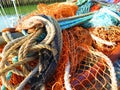 Yellow, rusty and blue mooring lines. Fishing nets, fishing industry, old rope and rusty metal Pulley system part on Royalty Free Stock Photo