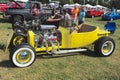 Yellow 1940's Ford T-bucket antique convertible car.