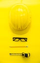 Yellow Safety Engineer and Cartridge, Pencil, glasses Put on yellow ground