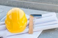 The yellow safety helmet and the blueprint at construction site Royalty Free Stock Photo