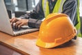 The yellow safety helmet and Business man in Construction industry is working in on computer. Royalty Free Stock Photo