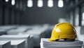 Yellow Safety Helmet on Stacked Papers in a Warehouse Setting with Blurred Background Royalty Free Stock Photo