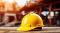 yellow safety helmet on the table with construction site on the background Royalty Free Stock Photo