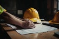 yellow safety helmet on workplace desk with construction Royalty Free Stock Photo