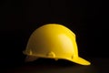 Yellow safety worker helmet on black background Royalty Free Stock Photo