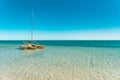 Yellow sailboat floating on turquoise crystal clear waters