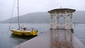 Yellow sailboat pitches at anchor on the quay