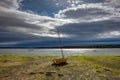 Yellow sailboat on the shoal in the port in Findhorn, Scotland Royalty Free Stock Photo