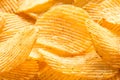 Yellow salted potato chips as background, closeup Royalty Free Stock Photo