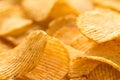 Yellow salted potato chips as background, closeup Royalty Free Stock Photo