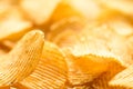 Yellow salted potato chips as background, closeup Royalty Free Stock Photo