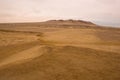 Yellow sand dunes and red mountains in the desert of Paracas National Reserve Royalty Free Stock Photo