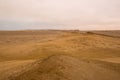 Yellow sand dunes and red mountains in the desert of Paracas National Reserve Royalty Free Stock Photo