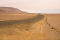 Yellow sand dunes and red mountains in the desert of Paracas National Reserve Royalty Free Stock Photo