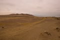 Yellow sand dunes and red mountains in the desert of Paracas National Reserve Royalty Free Stock Photo