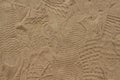 Yellow sand with foot marks photo texture. Shoe sole sand marks. Protecting feet on holiday. Royalty Free Stock Photo