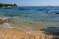 Yellow sand on the seashore. Blue clear sea water Royalty Free Stock Photo