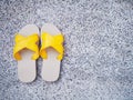 Yellow sandal on edge of swimming pool