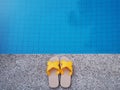 Yellow sandal by swimming pool Royalty Free Stock Photo