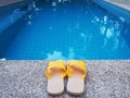 Yellow sandal by swimming pool Royalty Free Stock Photo