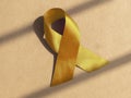 Yellow satin ribbon as medical symbolic loop Royalty Free Stock Photo