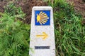 Yellow scallop shell, touristic symbol of the Camino de Santiago showing direction on Camino Norte in Spain. Column signing the Royalty Free Stock Photo