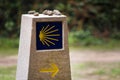 Yellow scallop shell, touristic symbol of the Camino de Santiago showing direction on Camino Norte in Spain. Column signing the Royalty Free Stock Photo