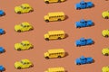 Yellow school bus, blue pickup truck and bug on a brown background. Pattern Royalty Free Stock Photo