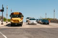 Yellow school bus and cars stopped at the red light on the road in Chicago Downtown, Illinois, USA Royalty Free Stock Photo