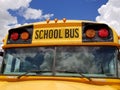 Yellow school bus with cloud reflection