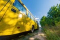 Yellow school bus on a country road Royalty Free Stock Photo