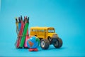 Yellow School bus and felt-tip pens on the roof, back to school concept, yellow background, copy space. education Royalty Free Stock Photo
